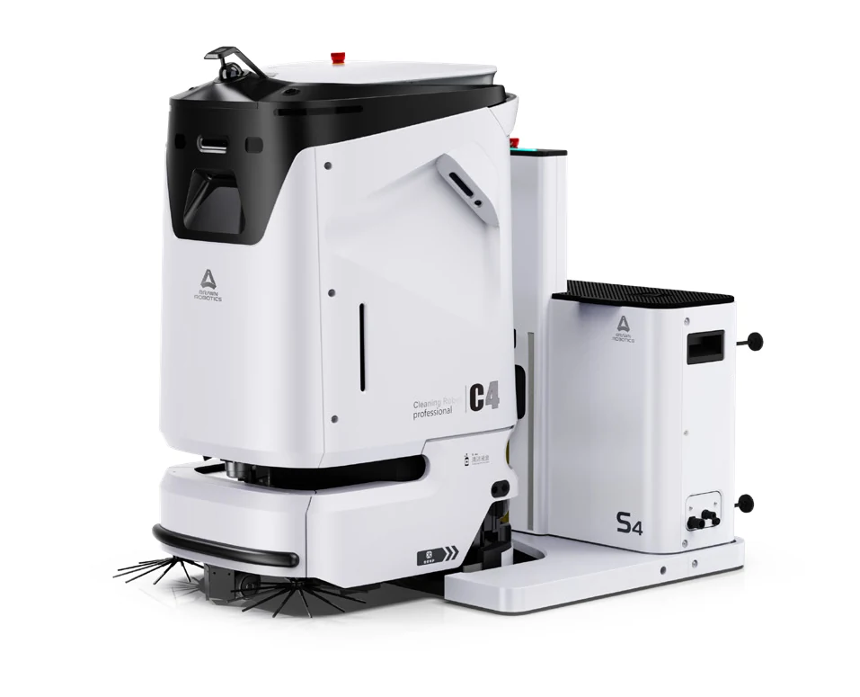 The AGIBOT C4 cleaning robot beside its docking station: a compact upright white machine with a black top panel and side brushes at floor level.